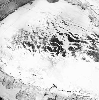 Oblique aerial view centred on the remains of the fort and settlement, taken from the SSW.