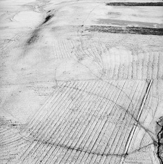 Morton Hill, oblique aerial view, taken from the SW, showing an area of rig and furrow cultivation across the photograph, and a sheepfold in the left centre.