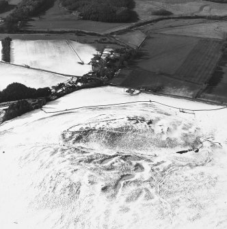 Oblique aerial view centred on remains of the fort with the village adjacent, taken from the SE.