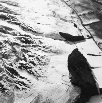 Oblique aerial view of the remains of the cultivation terraces, rig, sheepfold and settlement, taken from the ENE.