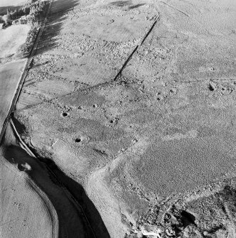 Oblique aerial view centred on the remains of the coal mines, shafts and subsidence pits, taken from the SE.