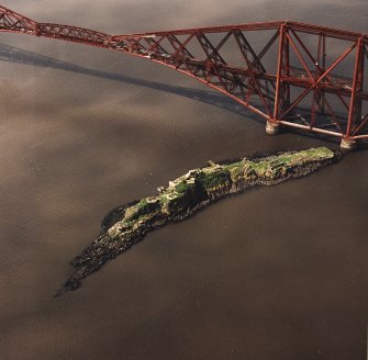 Oblique aerial view of The Forth Bridge and Inch Garvie centred on the rail bridge and the remains of a castle, battery, coast battery and artillery fortifications, taken from the NE.