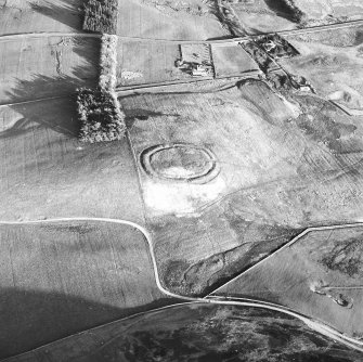 Oblique aerial view centred on the remains of the settlement, taken from the NNW.