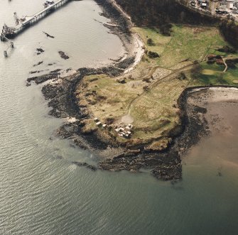 Oblique aerial view of Charles Hill centred on the remains of a coast battery and military camp with a ferry-house cellar adjacent, taken from the NE.