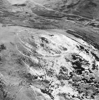 White Meldon, oblique aerial view, taken from the NE, centred on the fort and a cairn.