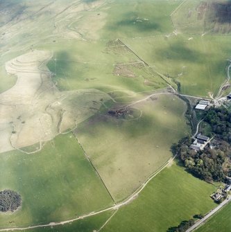 Oblique aerial view centred on the remains of the quarries with the remains of the fort and linear earthworks adjacent, taken from the NW.