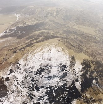 White Meldon, oblique aerial view, taken from the N, centred on the fort and a cairn.