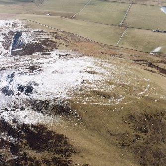 White Meldon, oblique aerial view, taken from the W, centred on the fort and a cairn.