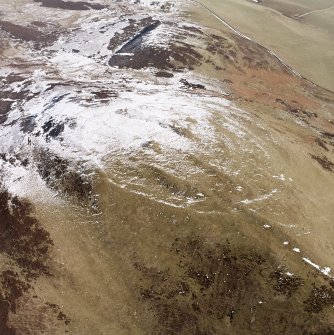 White Meldon, oblique aerial view, taken from the SW, centred on the fort and a cairn.