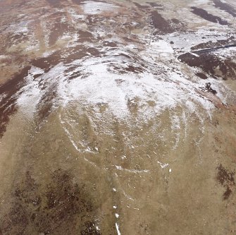 White Meldon, oblique aerial view, taken from the S, centred on the fort and a cairn.