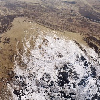White Meldon, oblique aerial view, taken from the NNE, centred on the fort and a cairn.