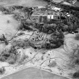 Oblique aerial view of Mavisbank House centred on the country house, earthwork, and cropmarks of a pond, taken from the WNW.