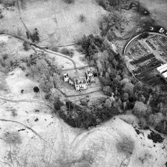 Oblique aerial view of Mavisbank House centred on the country house, earthwork, and cropmarks of a pond, taken from the WSW.