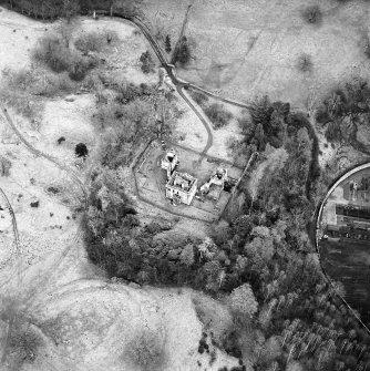 Oblique aerial view of Mavisbank House centred on the country house, earthwork, and cropmarks of a pond, taken from the NNW.