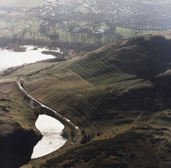 Oblique aerial view of Holyrood Park centred on the remains of cultivation terraces and rig, taken from the NNE.