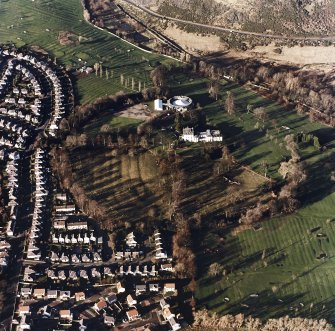 Oblique aerial view of Prestonfield centred on a golf course and rig with Prestonfield House and stables adjacent, taken from the SE.