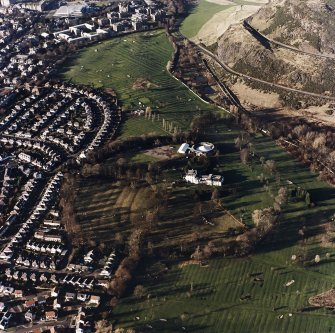 Oblique aerial view of Prestonfield centred on a golf course and rig with Prestonfield House and stables adjacent, taken from the ESE.