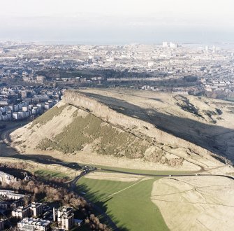 Oblique aerial view of Edinburgh, Holyrood Park centred on the remains of tracks, and Salisbury Crags, taken from the SSE.