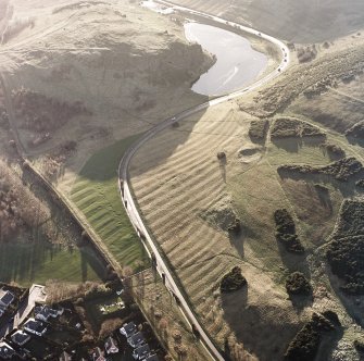 Oblique aerial view of Edinburgh, Holyrood Park centred on the remains of rig, taken from the SE.