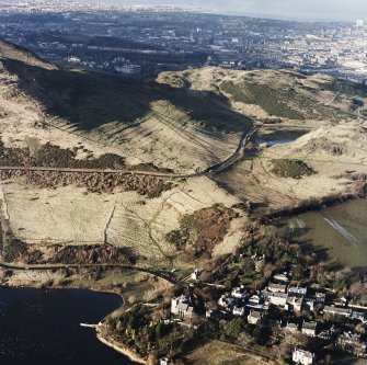 Oblique aerial view of Edinburgh, Holyrood Park centred on the remains of cultivation terraces, taken from the SE.