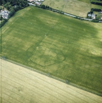 Oblique aerial view centred on the cropmarks of the enclosures with the country house adjacent, taken from the ESE.