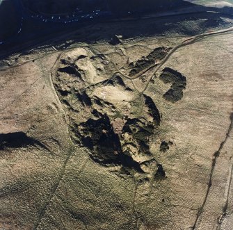 Oblique aerial view of Holyrood Park centred on the remains of quarries, taken from the S.