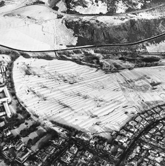 Oblique aerial view of Edinburgh, centred on Holyrood Park, taken from the SSE.