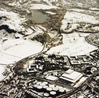 Oblique aerial view of Edinburgh, centred on Holyrood Park, taken from the E.