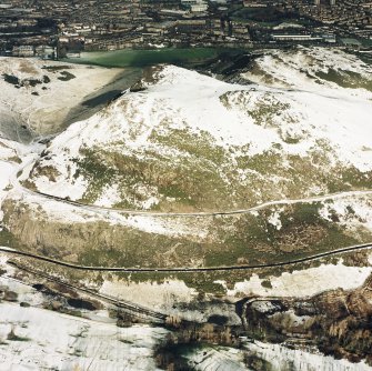 Oblique aerial view of Edinburgh, centred on Holyrood Park, taken from the S.