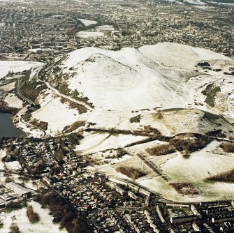 Oblique aerial view of Edinburgh, centred on Holyrood Park, taken from the NE.