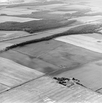 Oblique aerial view centred on the cropmarks of coal pits, taken from the NE.