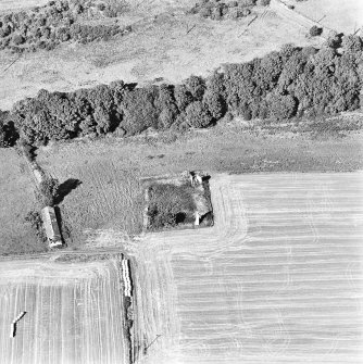 Oblique aerial view centred on the remains of the house with building adjacent, taken from the SSE.