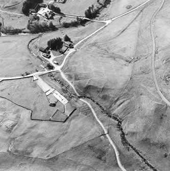 Oblique aerial view centred on the remains of the deserted settlement with the remains of the castle and possible field-system adjacent, taken from the SE.