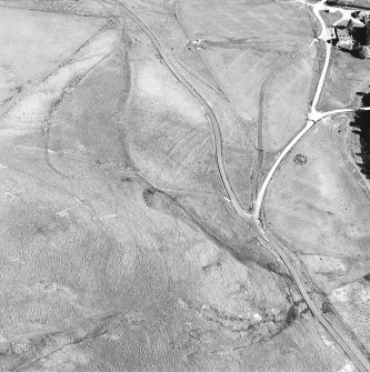 Oblique aerial view centred on the remains of the possible field-system, taken from the NW.