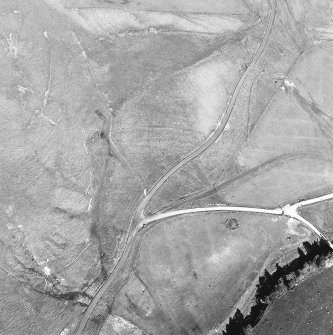 Oblique aerial view centred on the remains of the possible field-system, taken from the W.