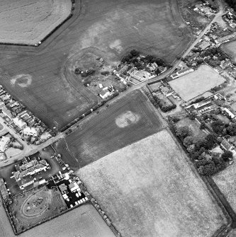 Hope Cottage, oblique aerial view, taken from the SSE, centred on the cropmarks of a possible enclosure.