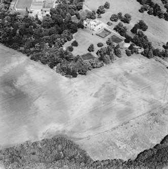 Oxenfoord Castle, linear cropmarks and cropmarks: oblique aerial view, taken from the S, centred on cropmarks of a possible formal garden and linear cropmarks. Oxenfoord Castle is visible in the top centre of the photograph.
