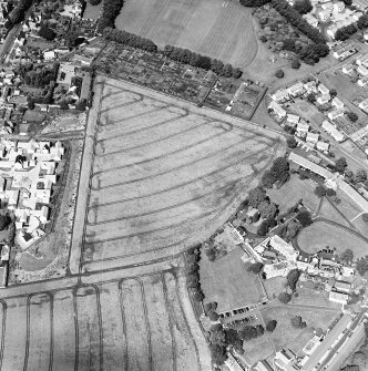 Oblique aerial photograph of Inveresk, taken from the SE, centred on the cropmarks of a field system.