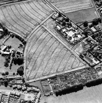 Oblique aerial photograph of Inveresk, taken from the N, centred on the cropmarks of a field system.