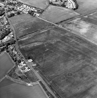 Oblique aerial view centred on the cropmarks of the cursus with the cropmarks of the field-system adjacent, taken from the S.