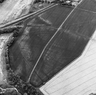 Inveresk: oblique air photograph of Roman temporary camps, enclosure, soilmarks, long cist cemetery and mineral railway