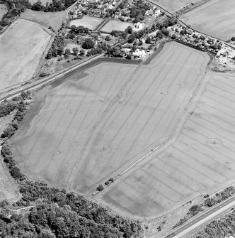Oblique aerial view centred on the cropmarks of the mineral railway and Roman temporary camp, taken from the SSW.