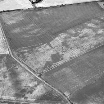 Howe Mire, oblique aerial view, taken from the SE, showing the cropmarks of a series of coal pits in the centre of the photograph.