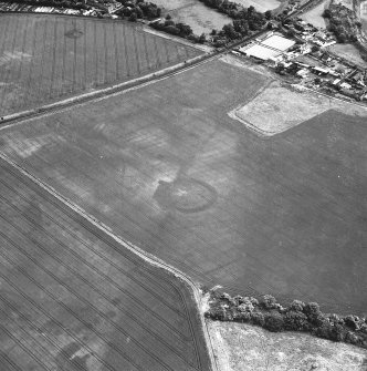 Brunstane, oblique aerial view, taken from the W, centred on the cropmarks of an enclosure, coal pits and shaft, a possible enclosure and rig.  Other cropmarks are also visible.