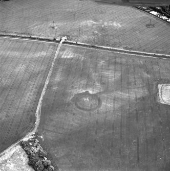 Brunstane, oblique aerial view, taken from the SW, centred on the cropmarks of an enclosure, coal pits and shaft, a possible enclosure and rig.  Other cropmarks are also visible.