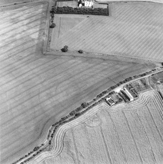 Oblique aerial photograph centred on the cropmark of a fort, taken from the SW. Falside castle is visible in the top centre of the photograph.