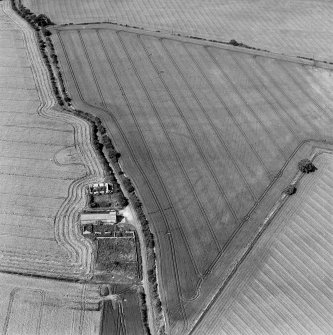 Oblique aerial photograph centred on the cropmark of a fort, taken from the ESE.