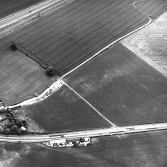 Dolphingstone, oblique aerial view, taken from the N, centred on a series of cropmarks.