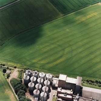 Oblique aerial view centred on the cropmarks of the fort with maltings adjacent, taken from the N.