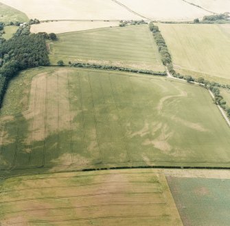 Oblique aerial photograph of Fala Dam, taken from the NE, centred on the cropmarks of a Roman temporary camp.